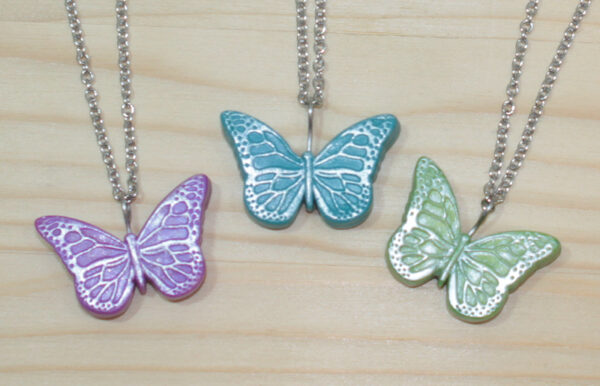Polymer clay butterfly with silver accent on stainless steel chain.