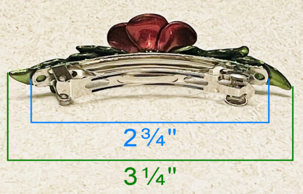 Red chrome color flower barrette with green leaves back side with measurements.